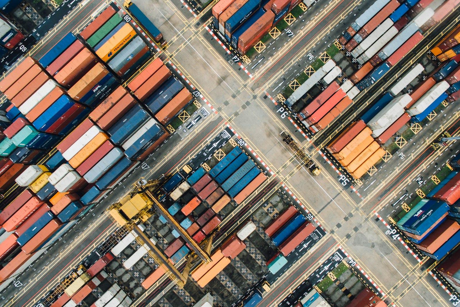 Aerial view of a container yard, shipping containers stacked in rows