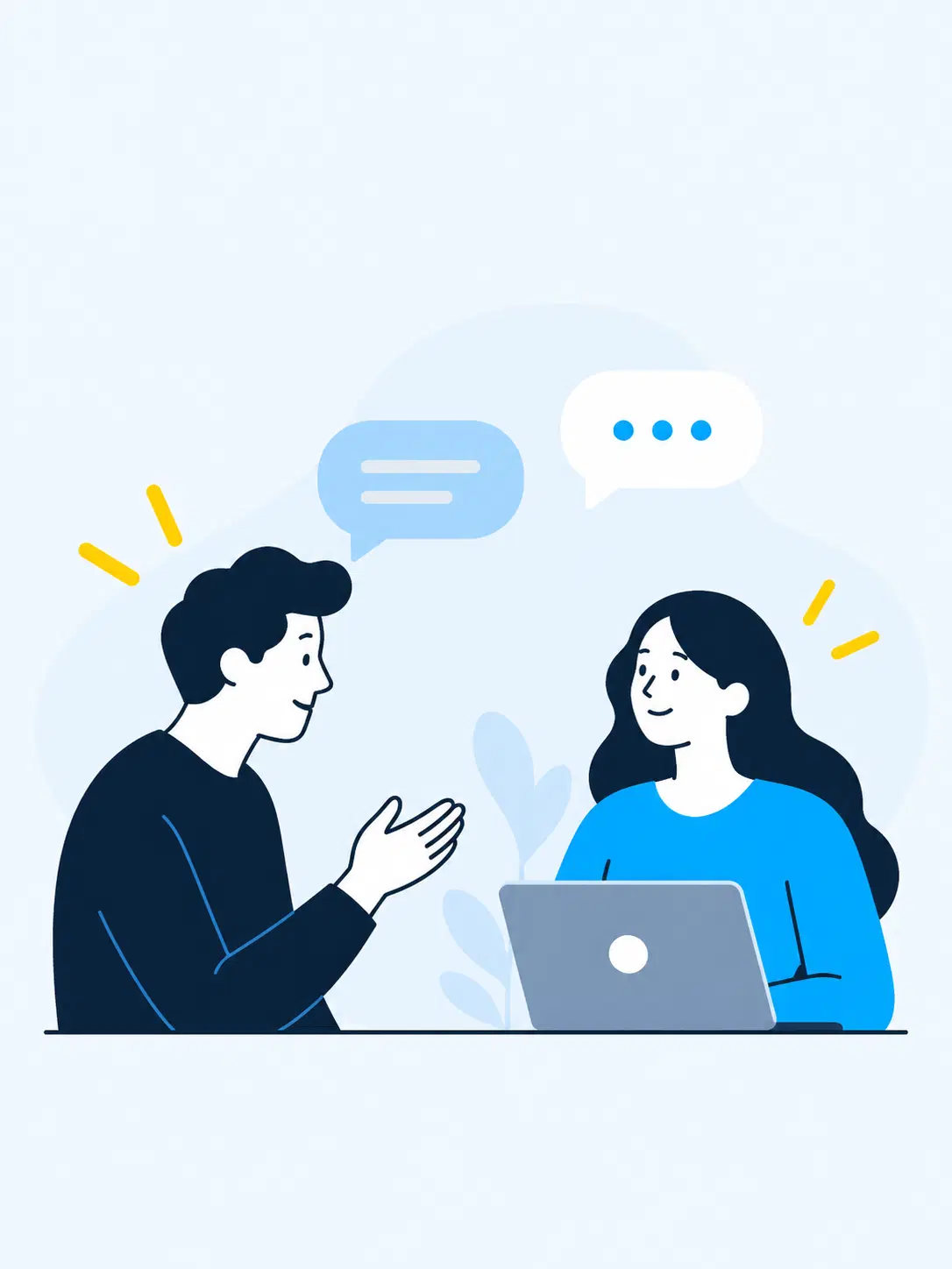 Two people in conversation across a table with a laptop